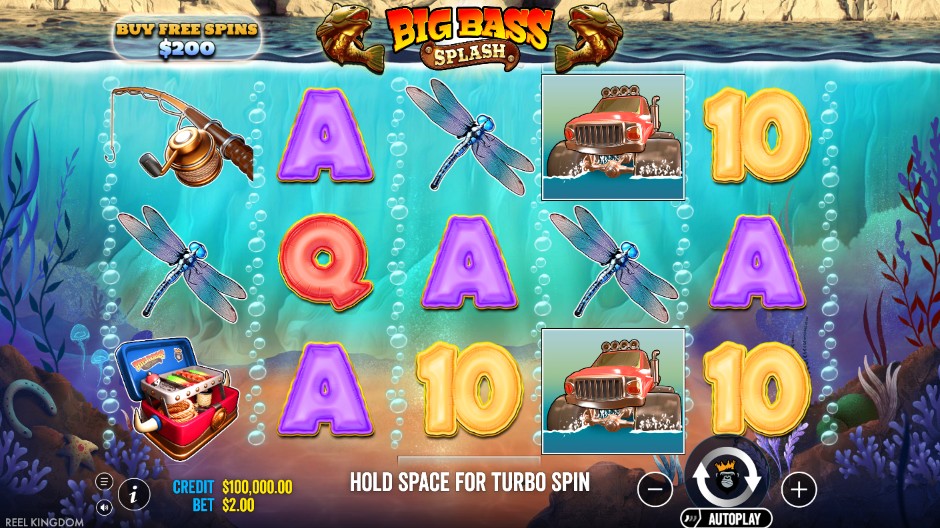 Big Bass Splash base game reels showing playing card symbols, a dragonfly, a tackle box, and the red truck symbol on a blue underwater background